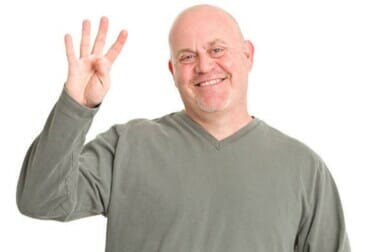 why do guys hold up 4 fingers in pictures